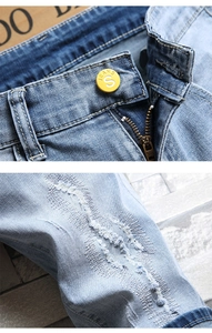 Vue macro détaillée d'un short en jean avec bouton jaune et fermeture éclair métallique YKK de qualité