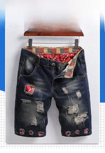 Detail of distressed denim shorts with unique red and black patterned hole lining