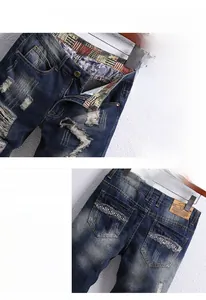 Detail of distressed denim shorts with vintage wash effects and American flag patchwork