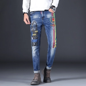 Detail of Bob Marley portrait print and colorful graffiti on slim fit denim jeans