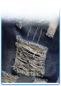 Detailed macro view of distressed ripped denim fabric with vintage frayed hole design