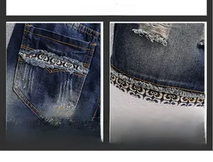 Detail of distressed denim shorts showing vintage wash effects and jacquard logo tape trim