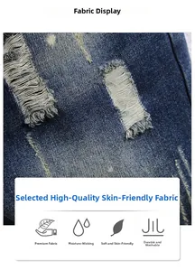 Detailed macro view of dark blue distressed denim fabric with ripped holes and whiskers