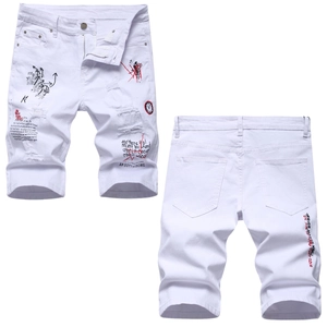 Slim fit white distressed denim shorts with artistic graffiti print and ripped details