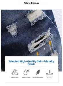 Nahaufnahme von blauem Denim-Stoff mit künstlerischen Farbspritzern und Riss-Details