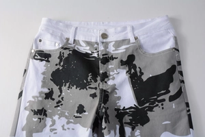 Detail of white camouflage jeans featuring silver button and belt loops close-up