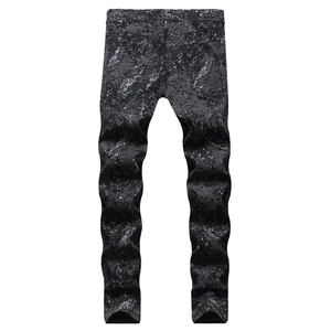 Slim fit black denim jeans with white paint splatter and contour map graffiti pattern