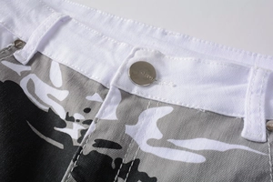 Detailed macro of white camo print jeans featuring silver metal button and fine stitching