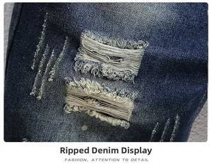 Macro shot of distressed denim fabric with ripped holes and raw edges on blue shorts