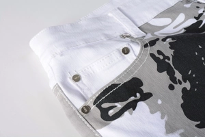 Detail of white camo denim fabric with metal rivets and precise stitching on waist