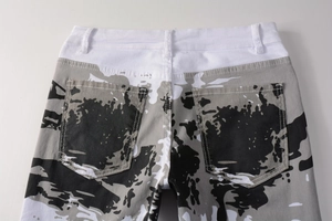 Close-up of white camouflage print denim pants featuring rear pockets and belt loops