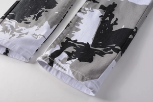 Detailed close-up of white camouflage printed denim fabric with precise stitching on leg cuff
