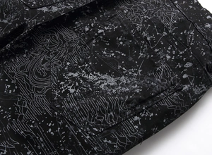 Detailed close-up of street style graffiti print on black denim pants back pocket