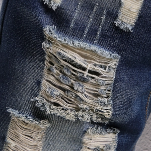 Men's retro washed denim shorts featuring heavy ripped details and a vintage finish