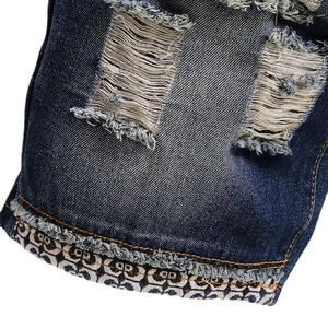 Men's retro distressed denim shorts with vintage geometric patterned fold-over hems