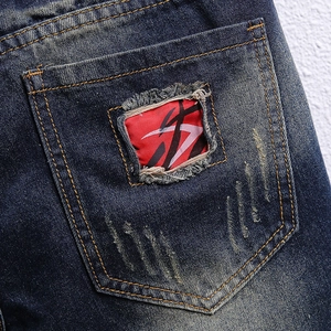 Men's retro distressed blue denim shorts featuring patchwork pockets and washed finish