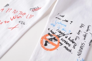 Detail of white slim jeans featuring colorful 3D graffiti prints and street style patterns