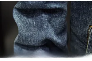 Macro shot of premium blue cotton twill denim fabric texture and soft wash finish