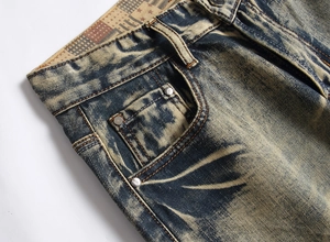 Macro shot of acid washed denim pocket with vintage metal rivets and golden contrast stitching