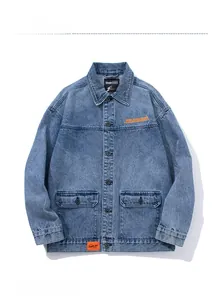 Detailed view of grey casual denim jacket with orange embroidery and functional patch pockets