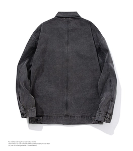 Detail view of washed grey denim jacket back featuring adjustable waist tabs and seam work