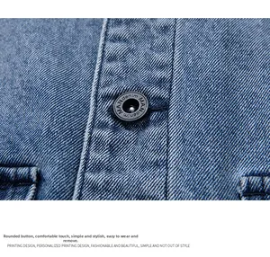Close-up of a black embossed button with MAN denim text on blue denim fabric texture