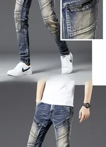 Detailed close-up of retro blue motorcycle jeans featuring metal zippers and pleated knees
