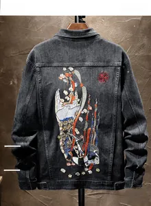 Macro detail of Chinese style embroidery featuring flowers and clouds on denim jacket back