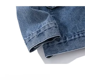 Detailed macro view of denim jacket cuffs and hem showcasing precise stitching and texture