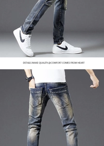 Detail of knee stitching and distressed wash on men's vintage slim fit moto jeans