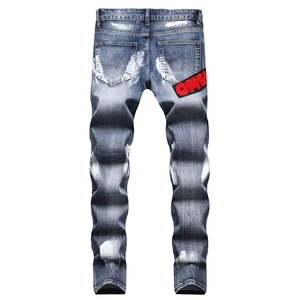 Men's slim blue jeans with hand-painted white splash and red 'OMG!' patch on the back