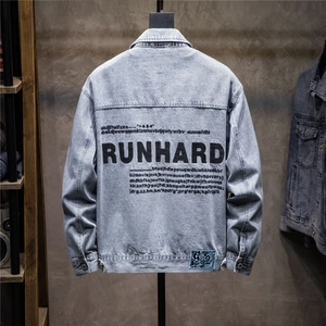 Detail of light blue denim jacket featuring black RUNHARD back print and vintage wash texture