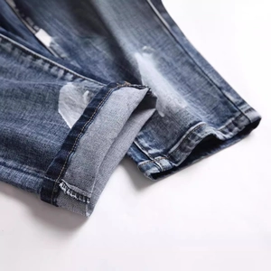 Men's retro blue straight denim pants with distressed white paint and badge embroidery detail