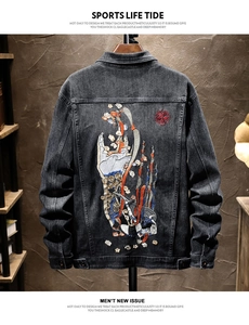 Detail of high-quality heavy embroidery with cloud and fire motifs on black denim jacket