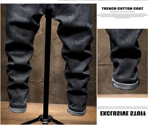 Detail view of washed slim-fit denim jeans featuring rolled cuffs and subtle textures