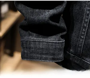 Close-up of sleeve cuff on black embroidery denim jacket showing twill fabric texture
