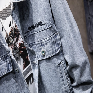 Macro detail of washed blue denim jacket featuring chest pocket and RUNHARD embroidery