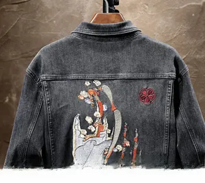 Detailed back view of grey denim jacket featuring intricate oriental scene embroidery