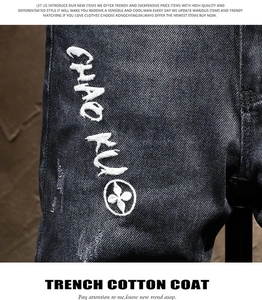 Detail of slim black denim fabric with white 'CHAO KU' embroidery and floral logo icon