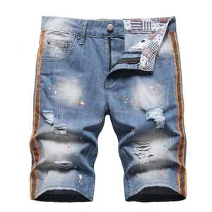 Men's light blue distressed denim shorts with paint splatters and side stripe tape