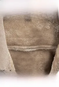 Detail of men's brown corduroy jacket showing thick warm fleece lining and fabric texture