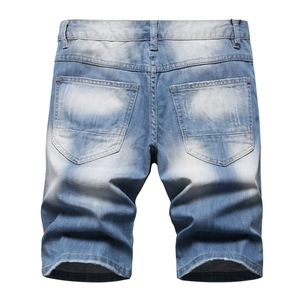 Men's light blue distressed denim shorts with reflective webbing and paint splatter effects