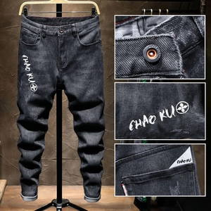 Slim fit black embroidered denim jeans for men with washed texture and floral details