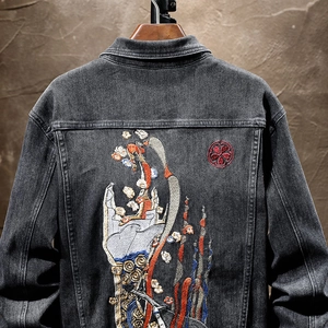 Men's black denim jacket with intricate oriental embroidery on the back and dragon style art