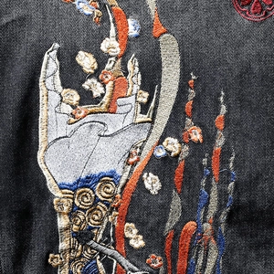 Men's black denim jacket with intricate colorful embroidery and traditional oriental motifs