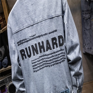 Detail view of denim jacket back featuring RUNHARD bold black letter print and wash texture