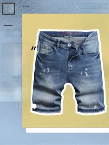 Detailed view of light blue denim shorts featuring unique white paint splatter wash design