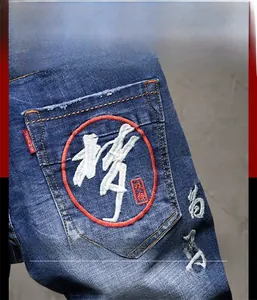 Detail der chinesischen Stickerei auf der Gesäßtasche dieser blauen Stretch-Denim-Shorts