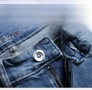 Detailed close-up of denim shorts featuring metal button and high-quality zipper fly