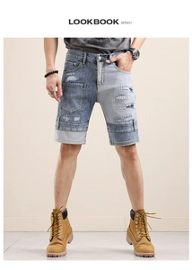 Detail of men's color-block denim shorts featuring distressed patches and frayed edges